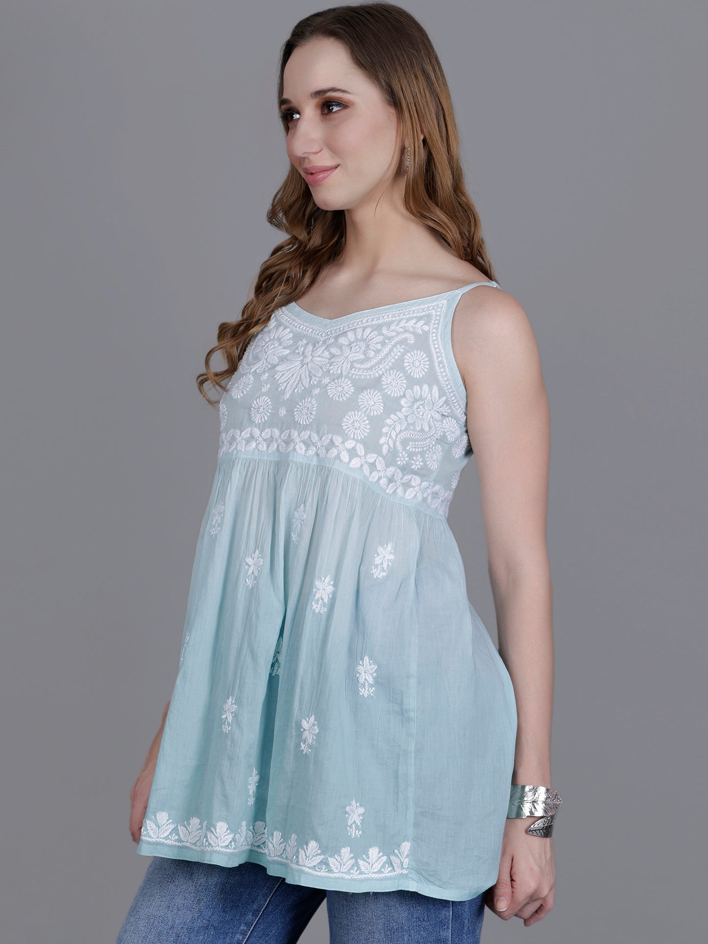 The Chikankari Story Handcrafted Sleeveless Chikankari Mul Cotton Top with Intricate White Floral Embroidery in Ombre Shades – Light Blue, Sea Green, Light Peach, Light Purple, Light Pink & Light Yellow.