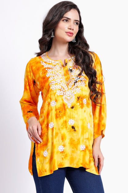 The Chikankari Story Embroidered Rayon Tie-Dyed Chikankari Yellow short Kurti with 3D Embroidery.