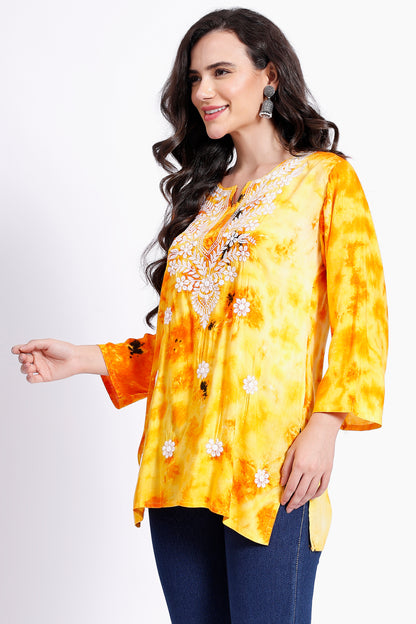 The Chikankari Story Embroidered Rayon Tie-Dyed Chikankari Yellow short Kurti with 3D Embroidery.