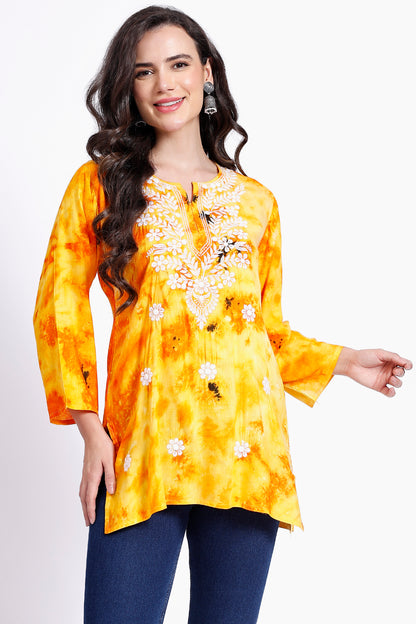 The Chikankari Story Embroidered Rayon Tie-Dyed Chikankari Yellow short Kurti with 3D Embroidery.