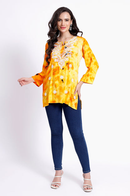 The Chikankari Story Embroidered Rayon Tie-Dyed Chikankari Yellow short Kurti with 3D Embroidery.