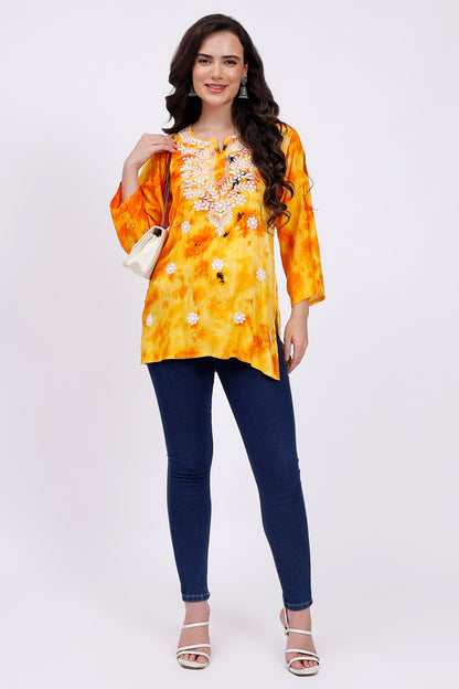 The Chikankari Story Embroidered Rayon Tie-Dyed Chikankari Yellow short Kurti with 3D Embroidery.